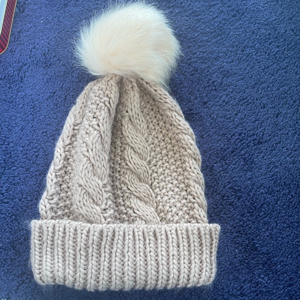 Light pink hat with a pompom